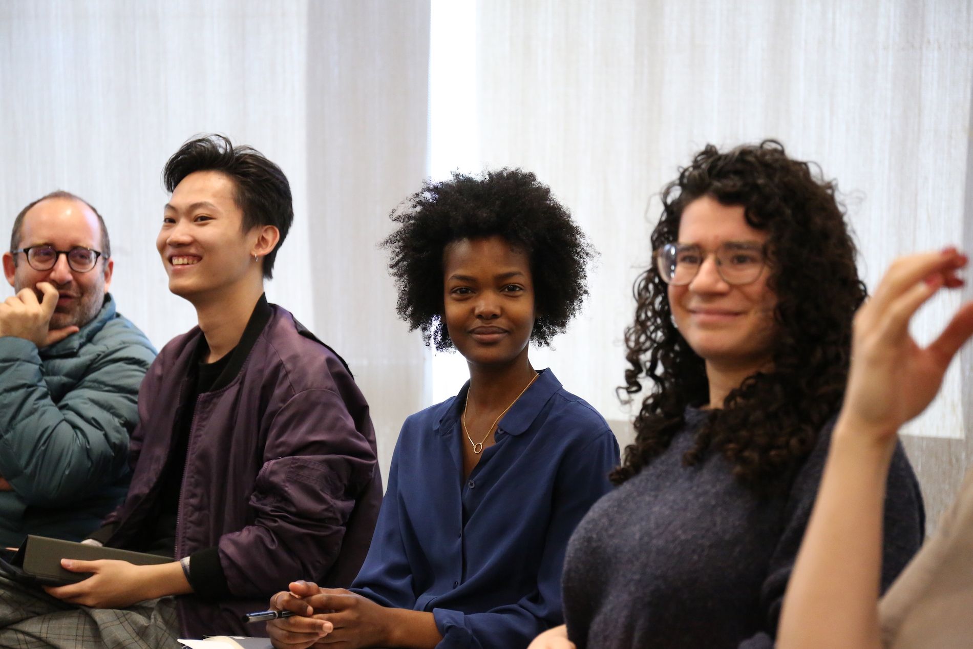 Four students sit in class for Ross Gay workshop with Language as Action class